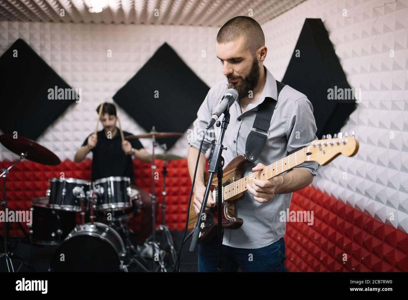Rock band working in music recording studio Stock Photo Alamy