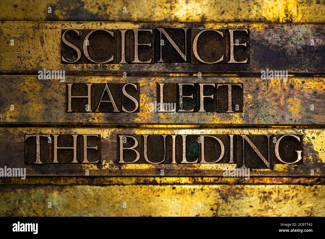 Science Has Left The Building text formed with real authentic typeset letters on vintage textured silver grunge copper and gold background Stock Photo