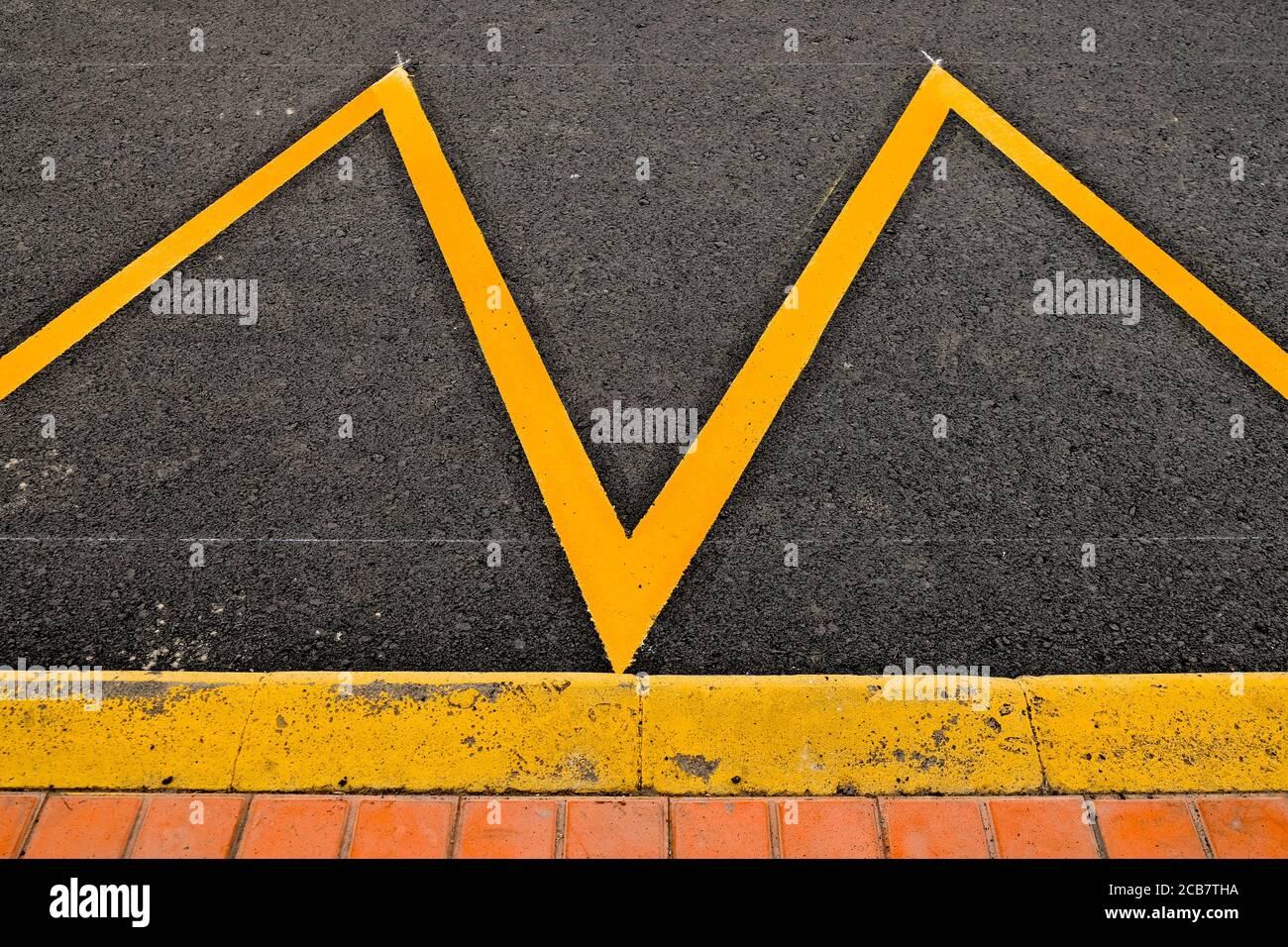 Parking space at a sidewalk marked in yellow reflective paint, an abstract detail Stock Photo