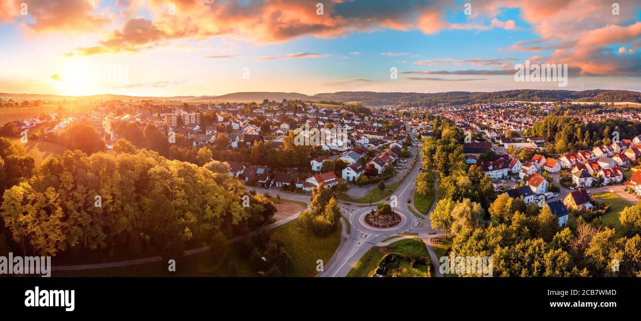 Aerial panorama of a European town at sunrise, with magnificent colorful sky and warm light Stock Photo