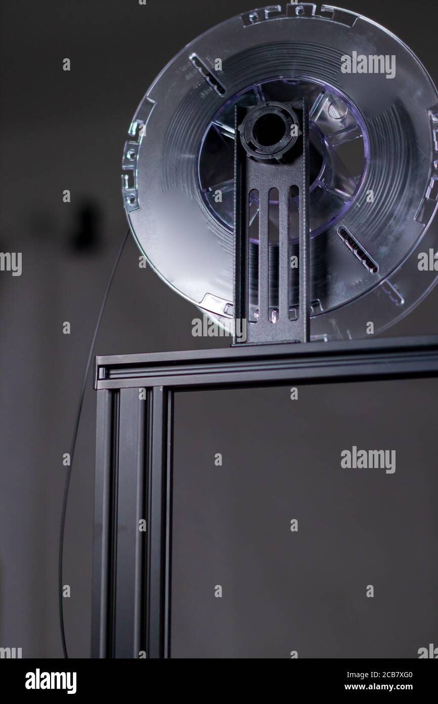 3D printer working in a factory printing plastic part. Stock Photo