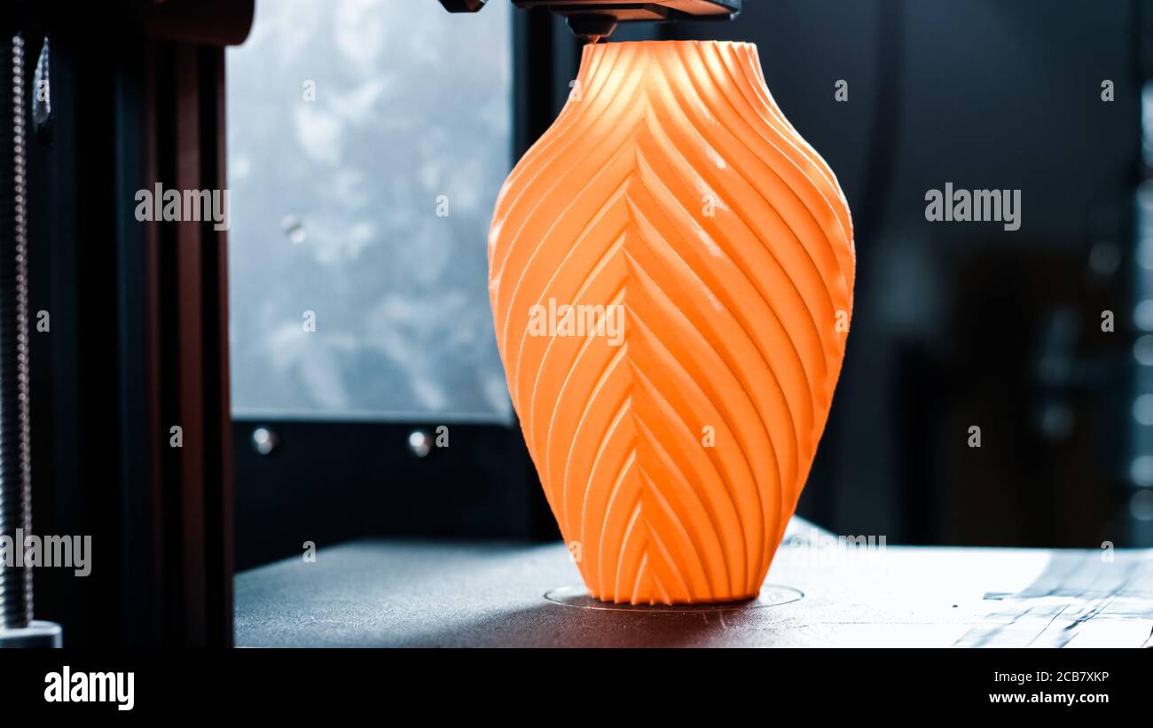 3D printer working in a factory printing plastic part. Stock Photo