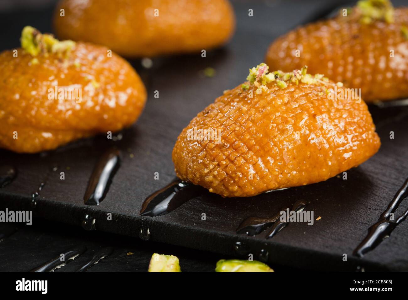 Arabic pastry sweet. Traditonal turkish baklava. Syrian Turkish Arab pistachio sweets on a dark
