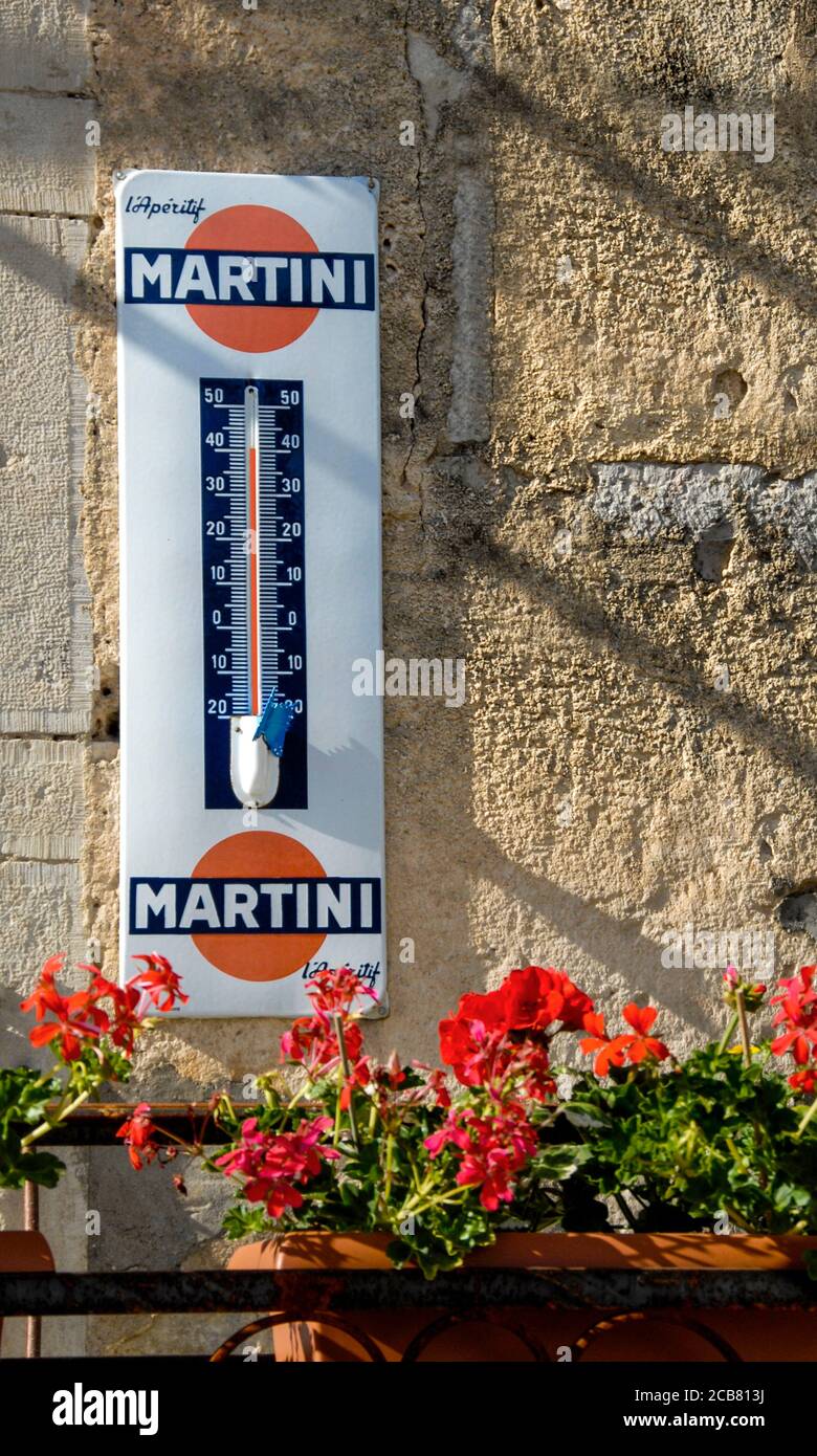 French Heat Wave Martini branded (L'Aperitif) wall thermometer temperature  gauge showing 40C (104 F) in late afternoon sunshine surrounded by  geraniums in rustic Provence France Stock Photo - Alamy