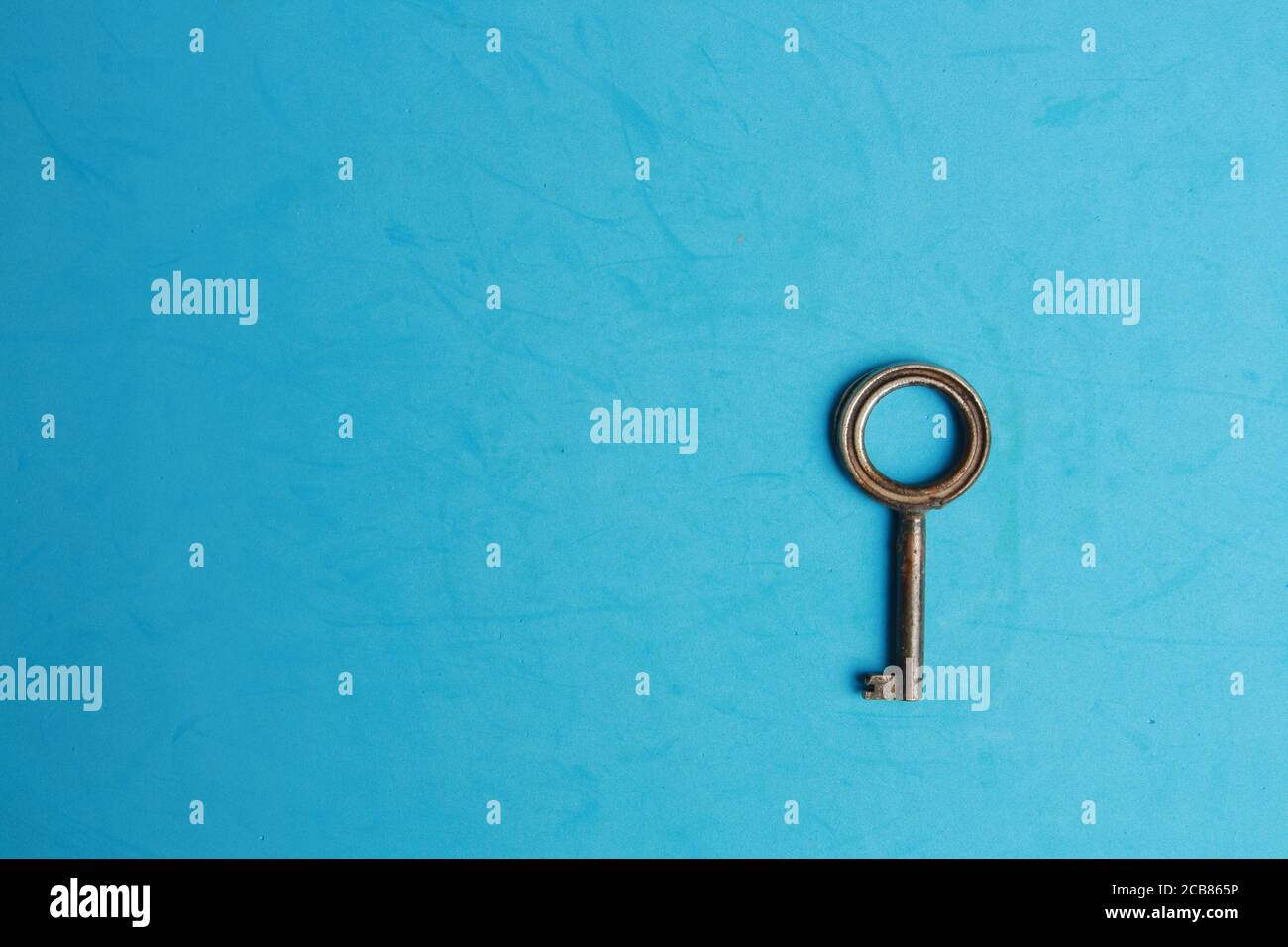 Key isolated on blue background Stock Photo