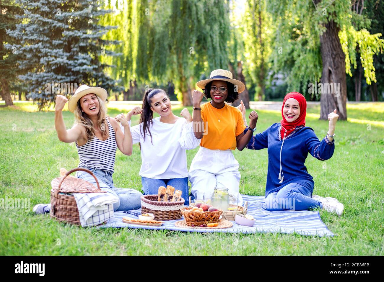 Young multiracial women are on picnic in the park. Stock Photo