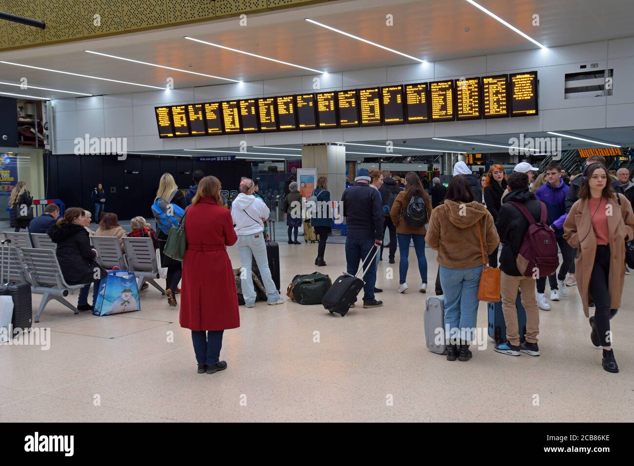 Passengers waiting for train announcements watching the departures