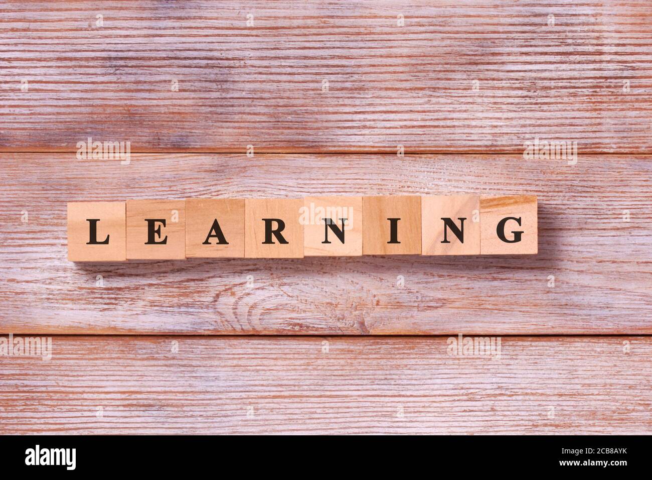 Learning word written on wood block. Concept of online course of ...