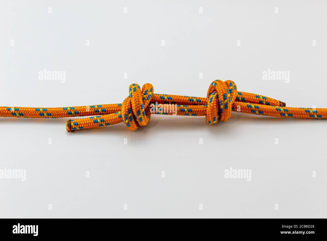 double fisherman's knot orange rope example of with white background Stock Photo