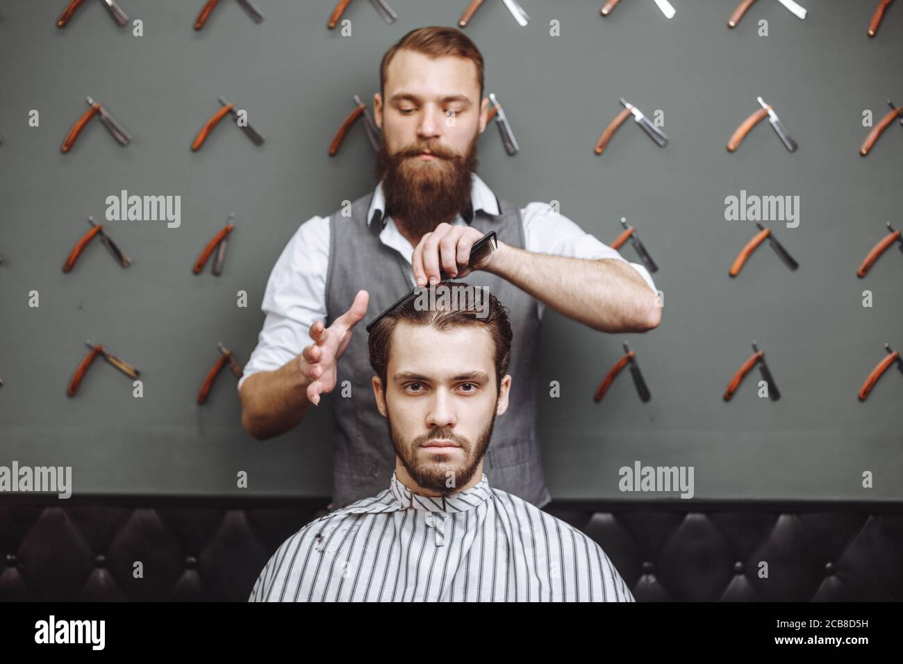 Barber using scissors and comb. Hair Care Service Concept Stock Photo