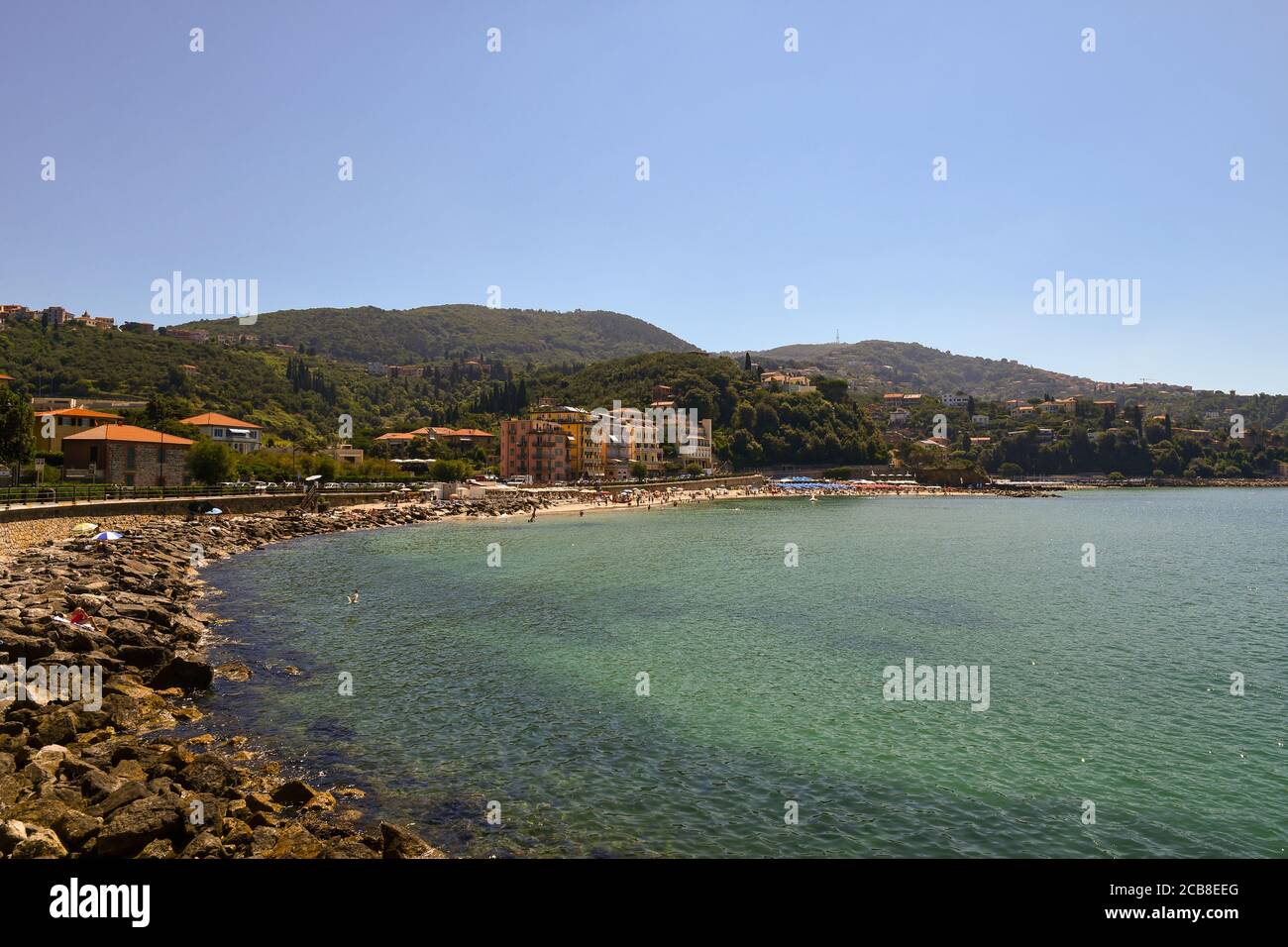 Scenic view of the bay with rocks and sandy beach on the shore of the Gulf of the Poets and the wooded hills in summer, Lerici, Liguria, Italy Stock Photo