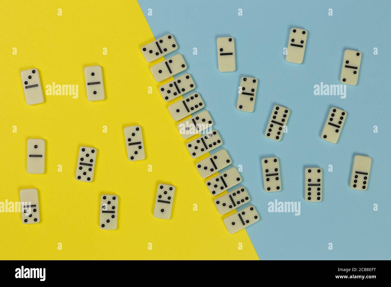 domino game concept, tiles organized in even and odd on the two-tone yellow and blue surface, top view Stock Photo