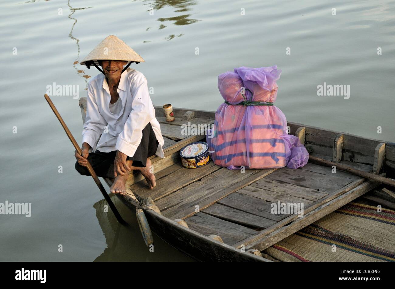 Happy old man on a wooden boat in Hoi An, Vietnam Stock Photo