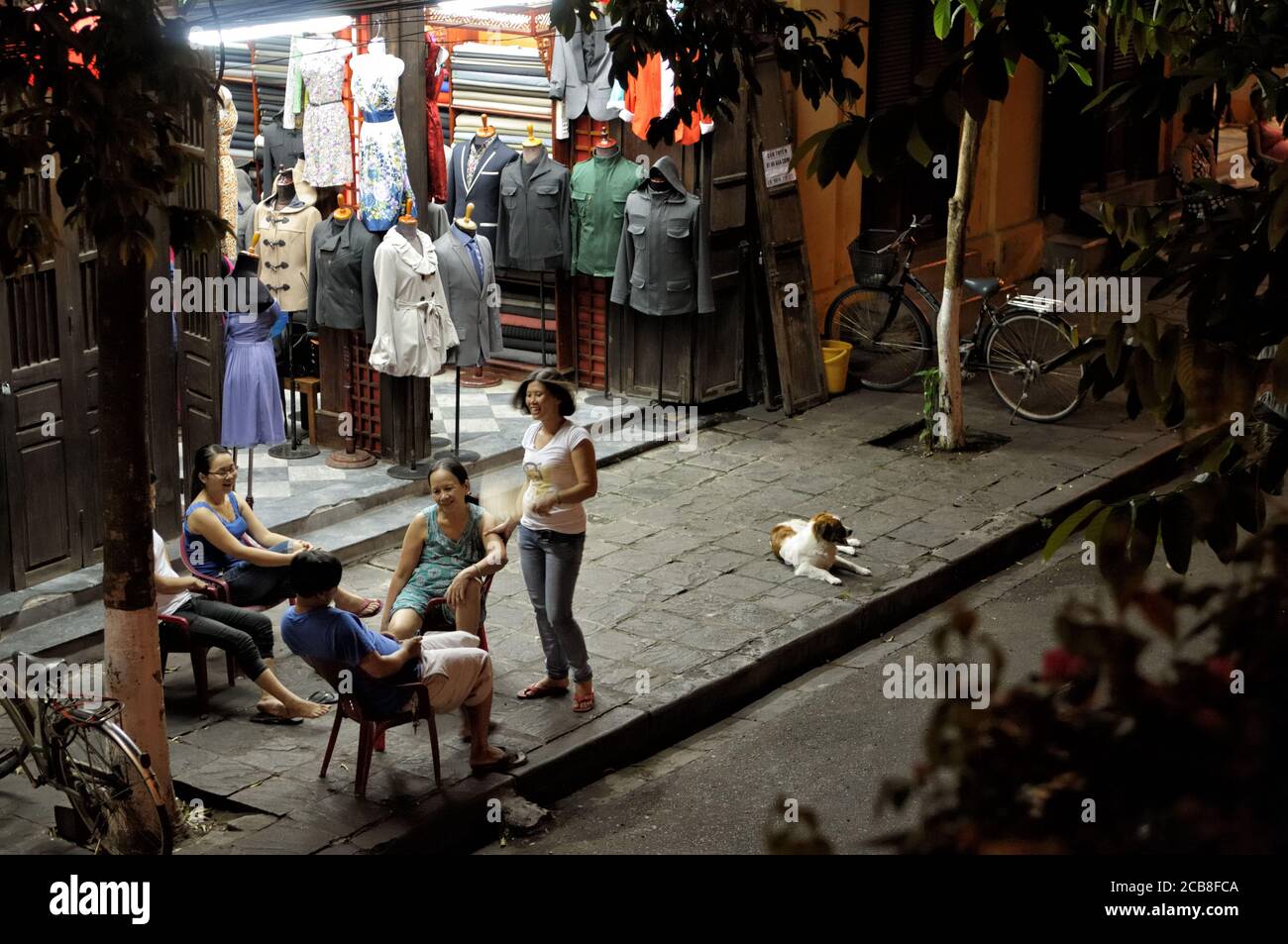 Family of tailors on the street in Hoi An, Vietnam Stock Photo