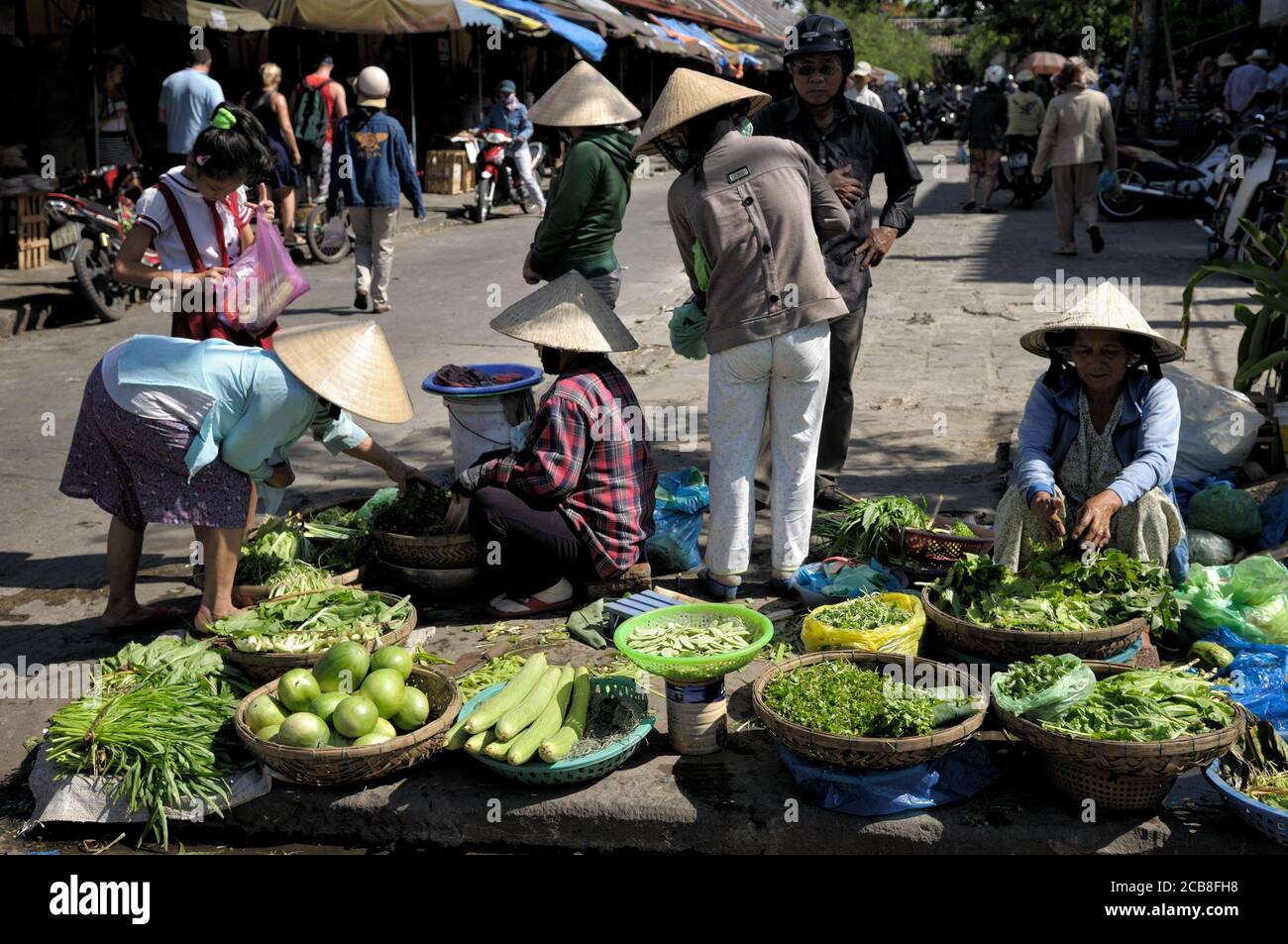 Women and vegetables at Hoi An market, Vietnam Stock Photo