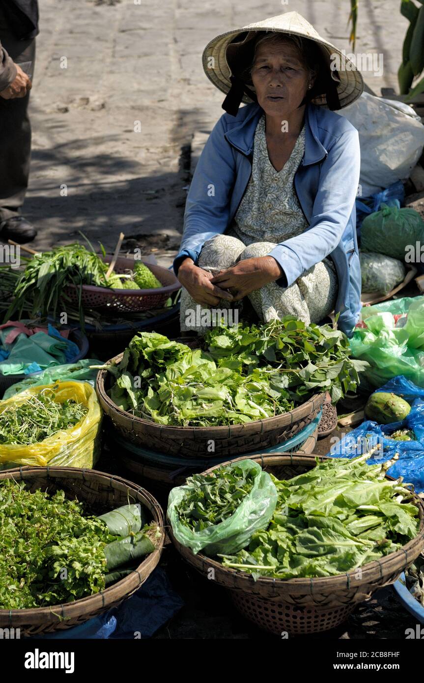 Green vegetables saleswoman at Hoi An market, Vietnam Stock Photo