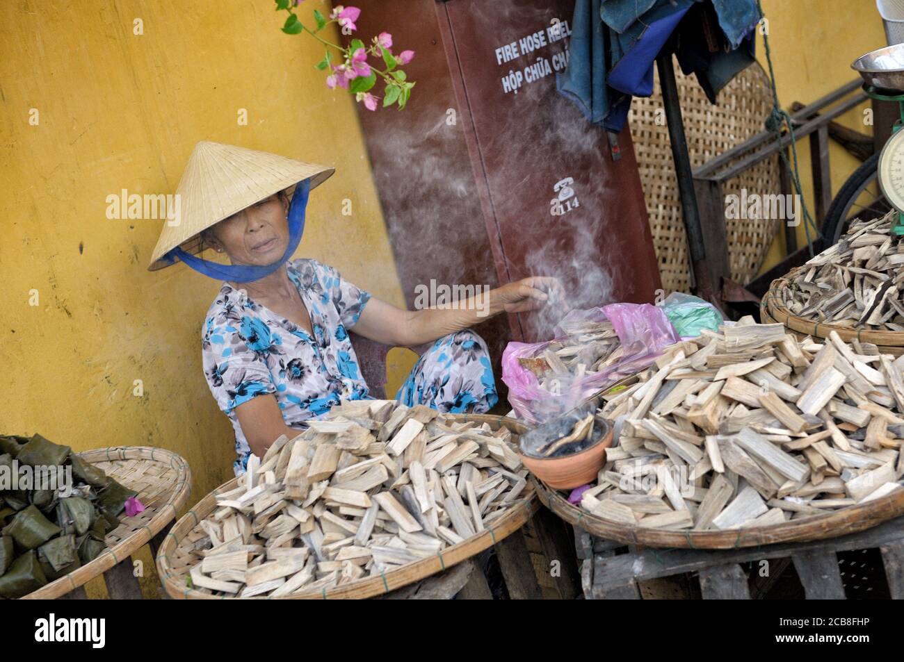 Small wood saleswoman at Hoi An market, Vietnam Stock Photo