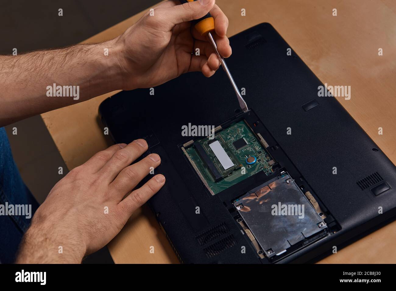 man using screwdriver and repairing a broken laptop for clients, close up  photo. profession, occupation, hobby, free time Stock Photo - Alamy