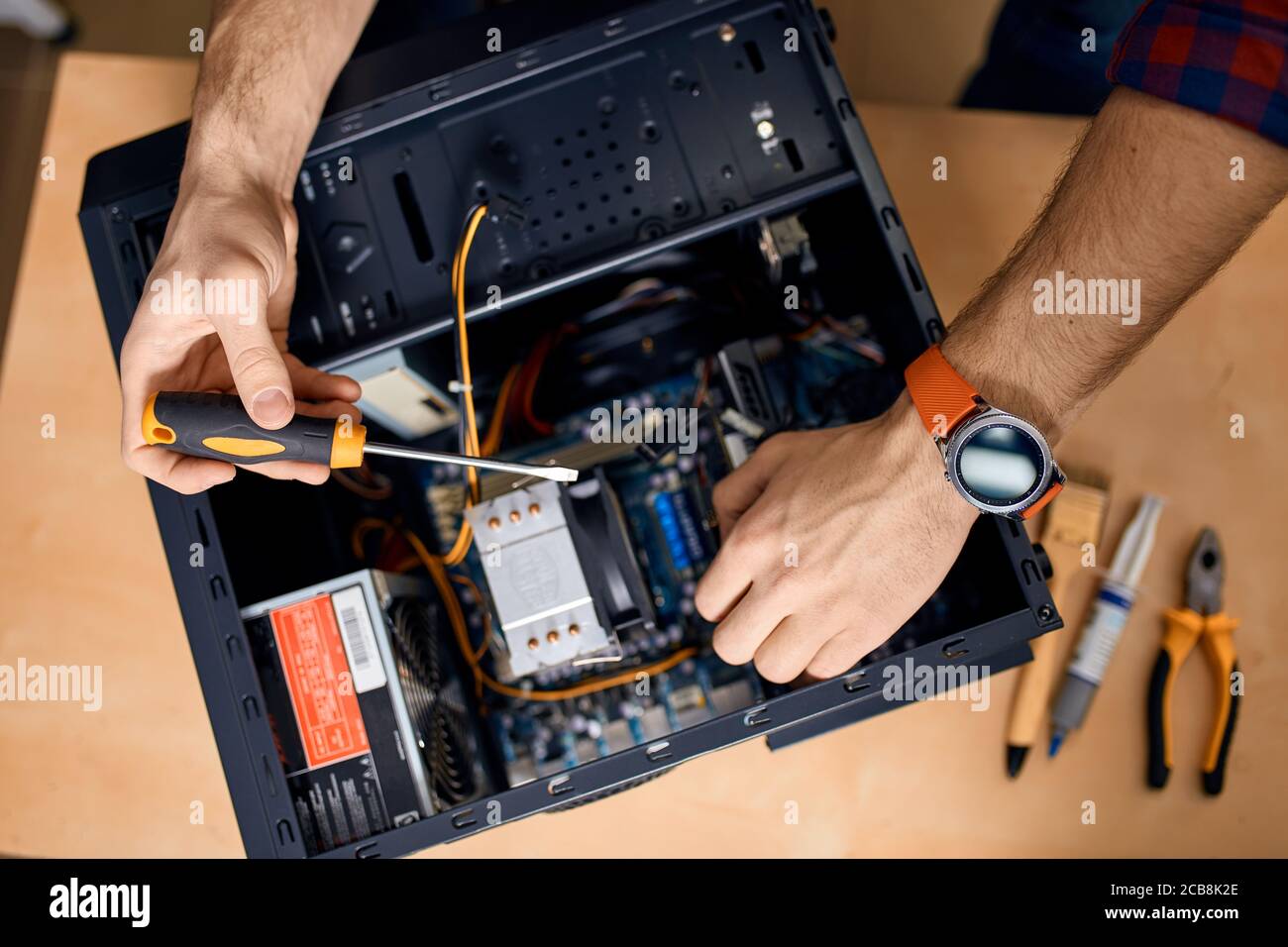 man taking off part of desktop system unit. guy is good at repairing a ...