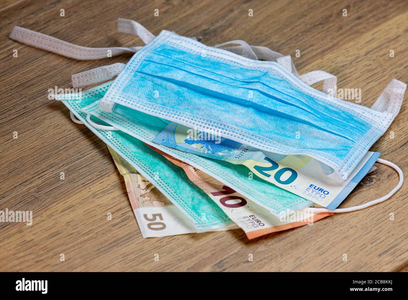 covid-19 epidemic speculation concept, stack of masks and money Stock Photo