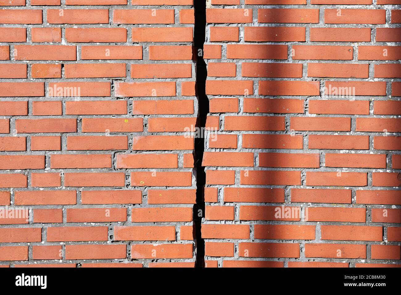 Red brick wall with a crack Stock Photo