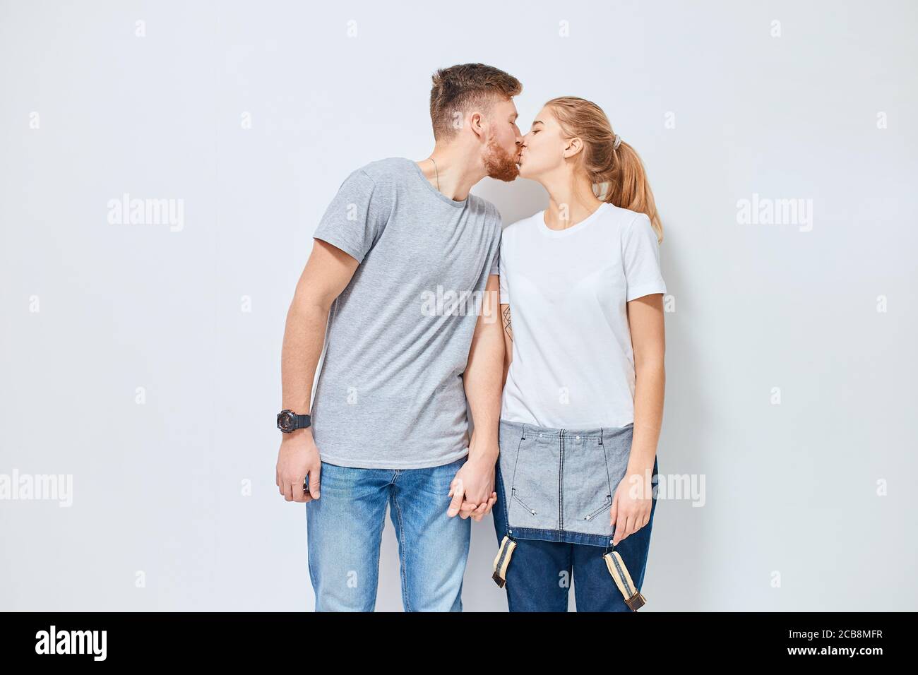 Cute young happy couple in love smiling holding hands and kissing ...
