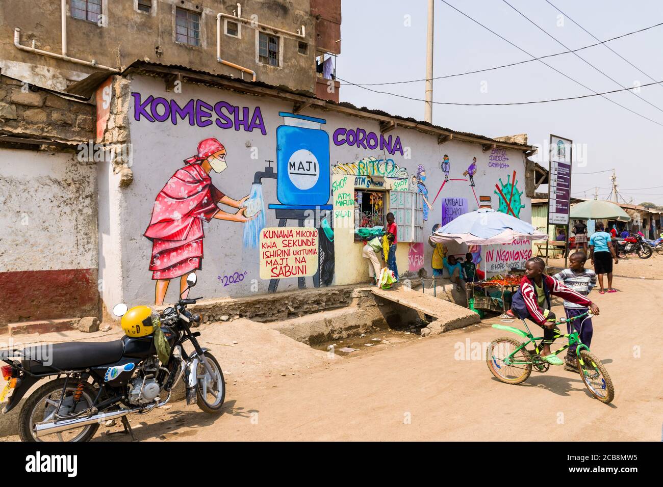 A roadside shop with a large painted mural saying Komesha Corona or Stop Corona and an image of a woman washing their hands, Nairobi, Kenya Stock Photo