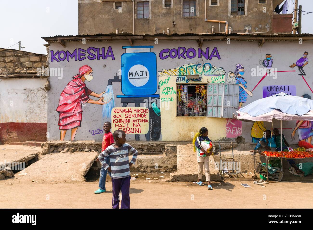 A roadside shop with a large painted mural saying Komesha Corona or Stop Corona and an image of a woman washing their hands, Nairobi, Kenya Stock Photo