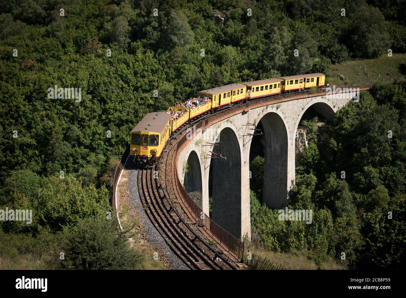French Pyrenees:Since 1910, the Yellow Train runs from Villefranche-de-Conflent to Latour-de-Carol. Here, it crosses the Pont de Via, near Font Romeu. Stock Photo