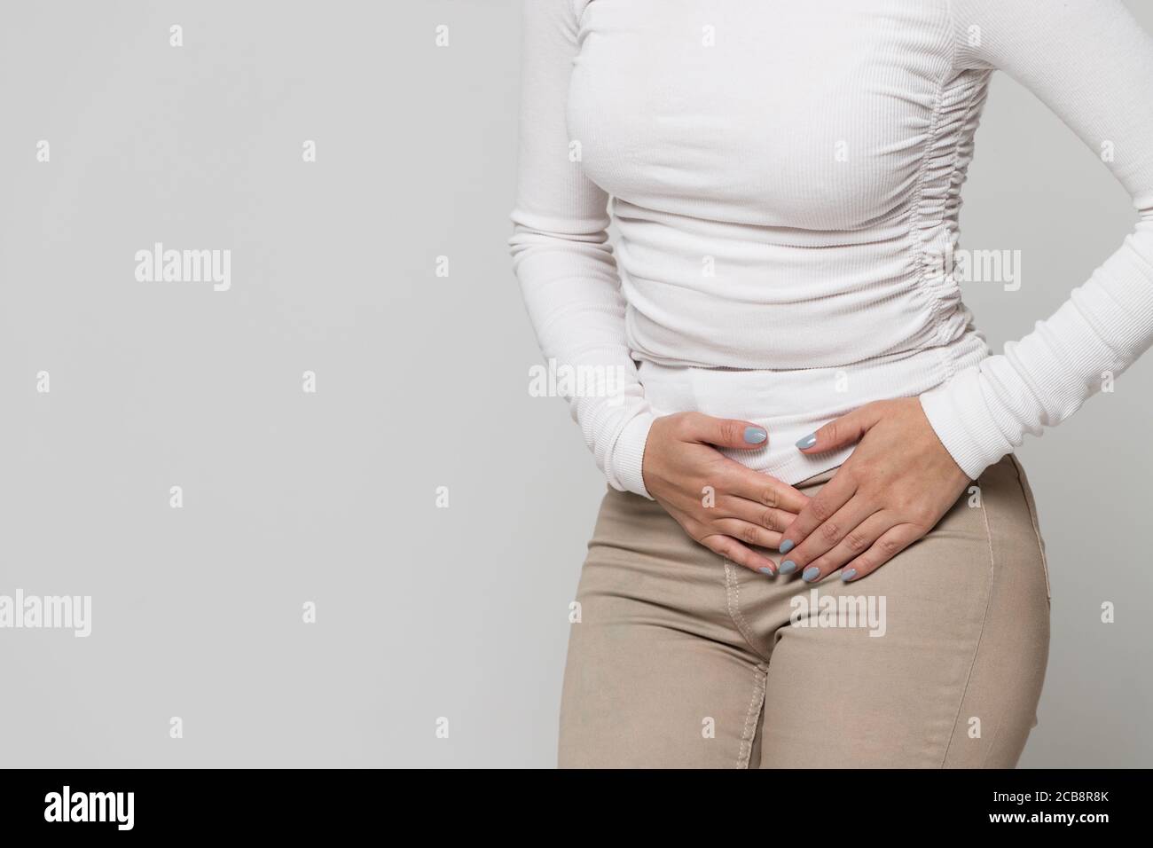 Health issues problems. Woman suffering from stomach pain, feeling abdominal pain or cramps. Period menstruation, female health problem, aching belly Stock Photo