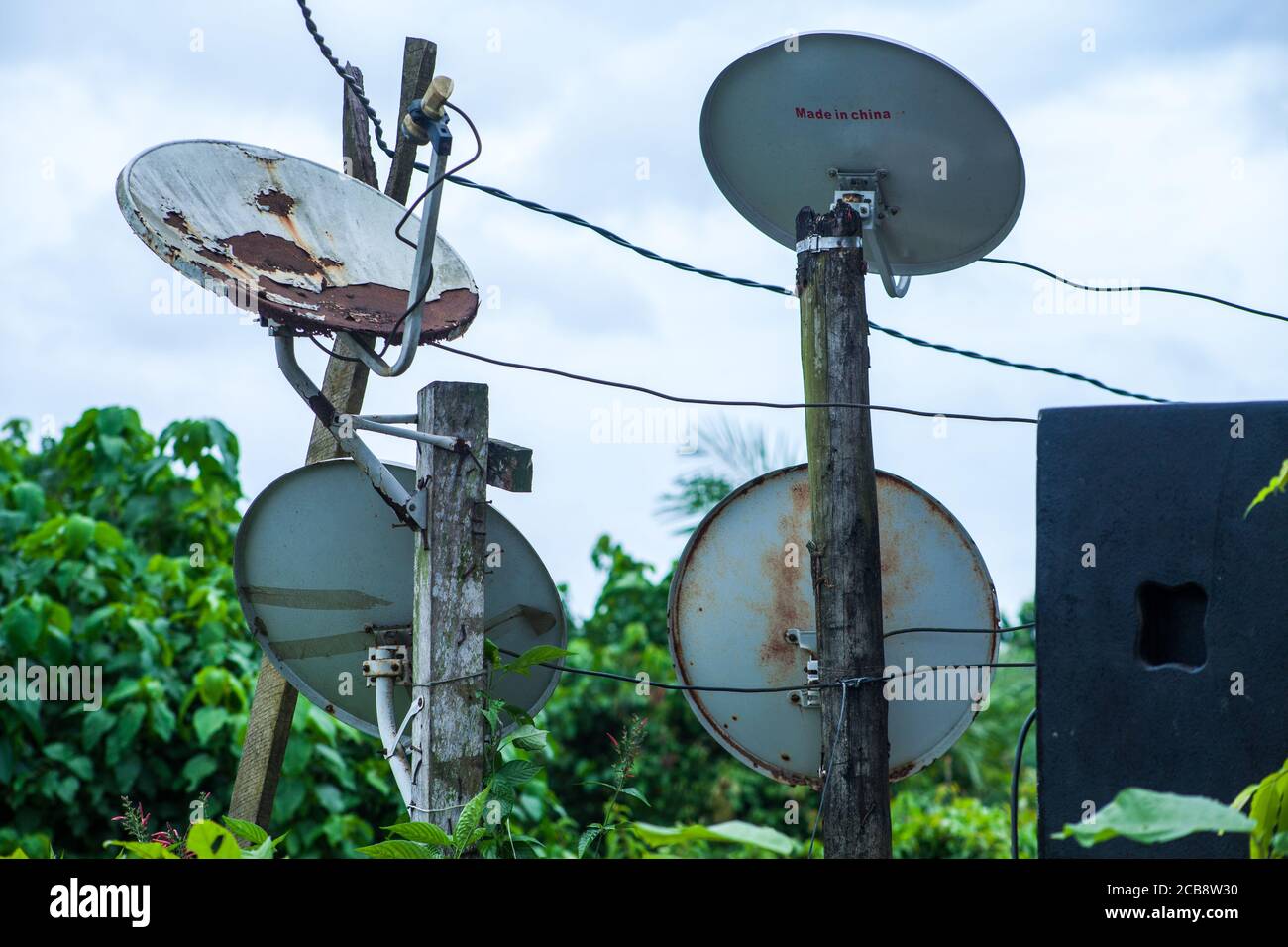 Four mini satellite dishes supplying cable TV to home in under-developed parts of the city of Douala in Cameroon. Stock Photo