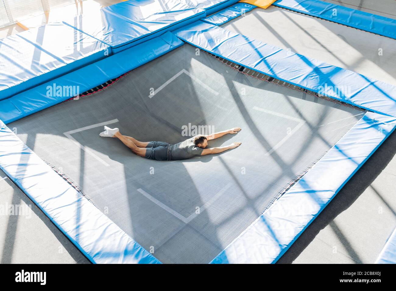 fit man lying on the bounce mat. full length portrait.gymnastics, trampoline  workout Stock Photo - Alamy