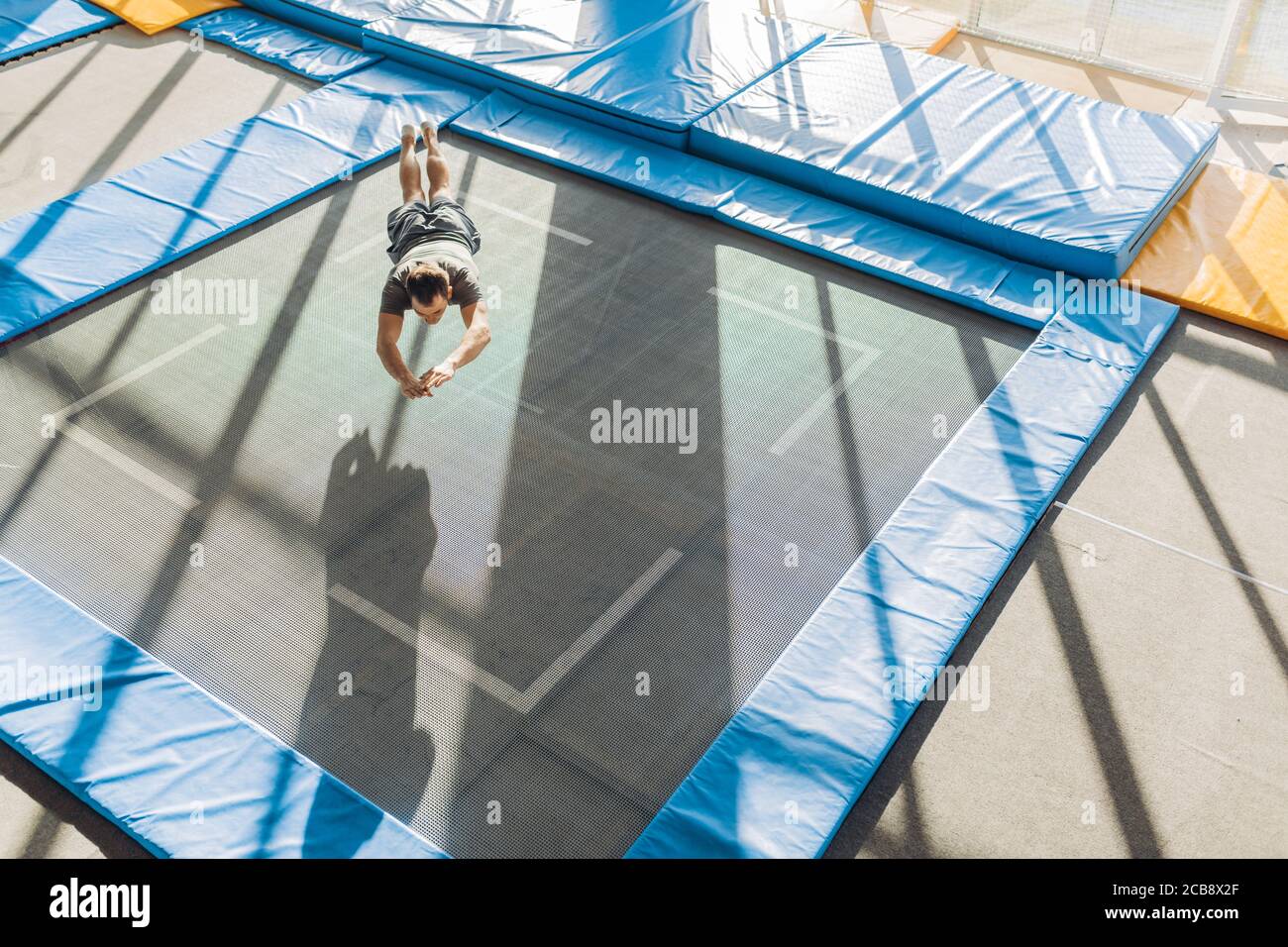 technique of falling on the trampoline. full length photo. copy space. sky  jump Stock Photo - Alamy