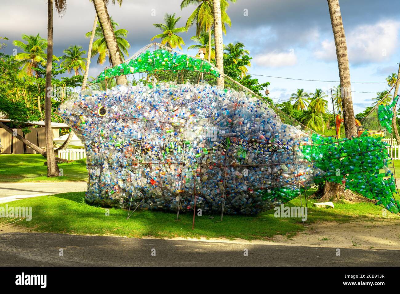 Fish artwork made by plastic bottles under the palm trees in the beach