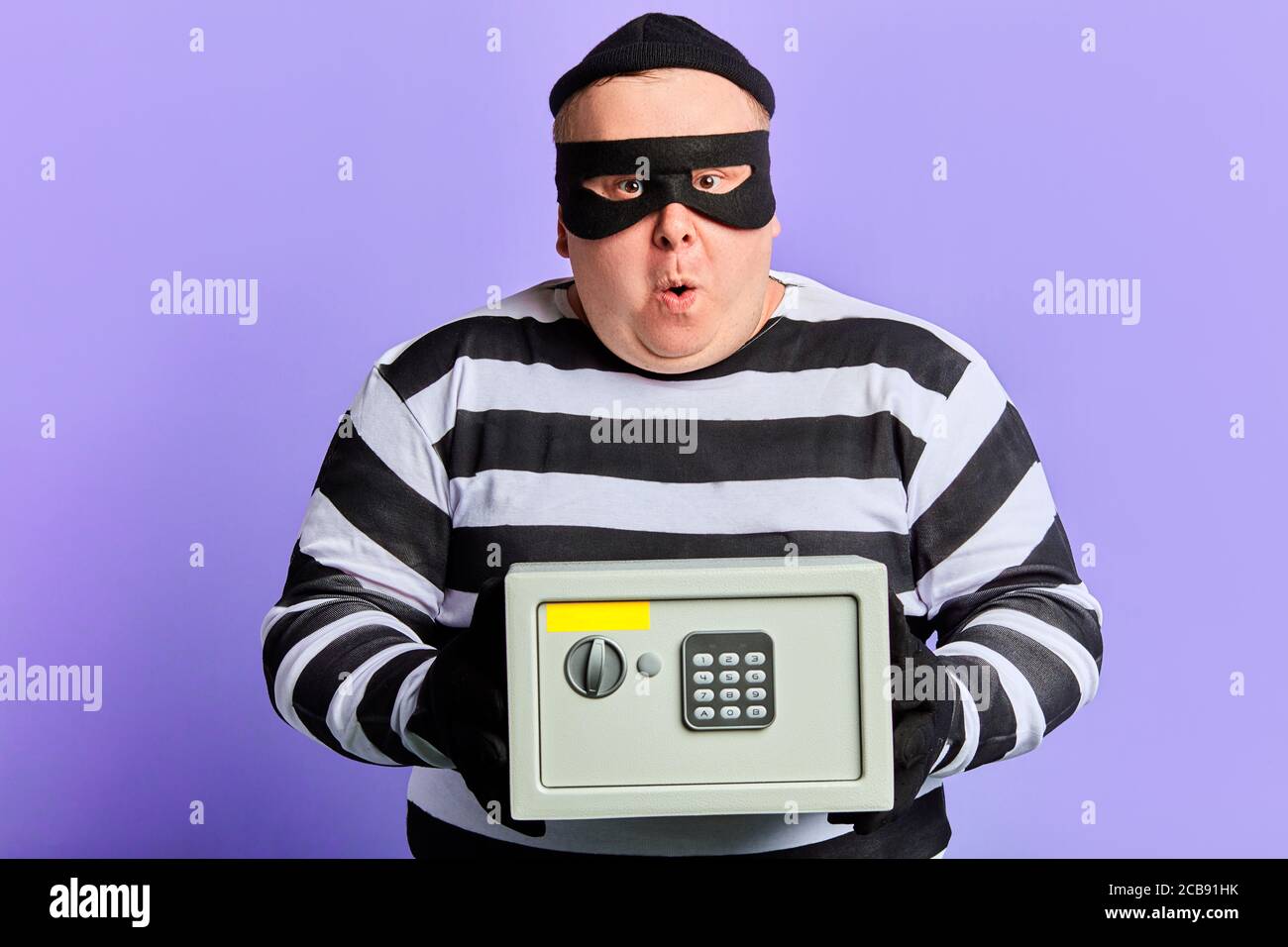 puzzled unhappy man cannot open the safe, difficulties in crime