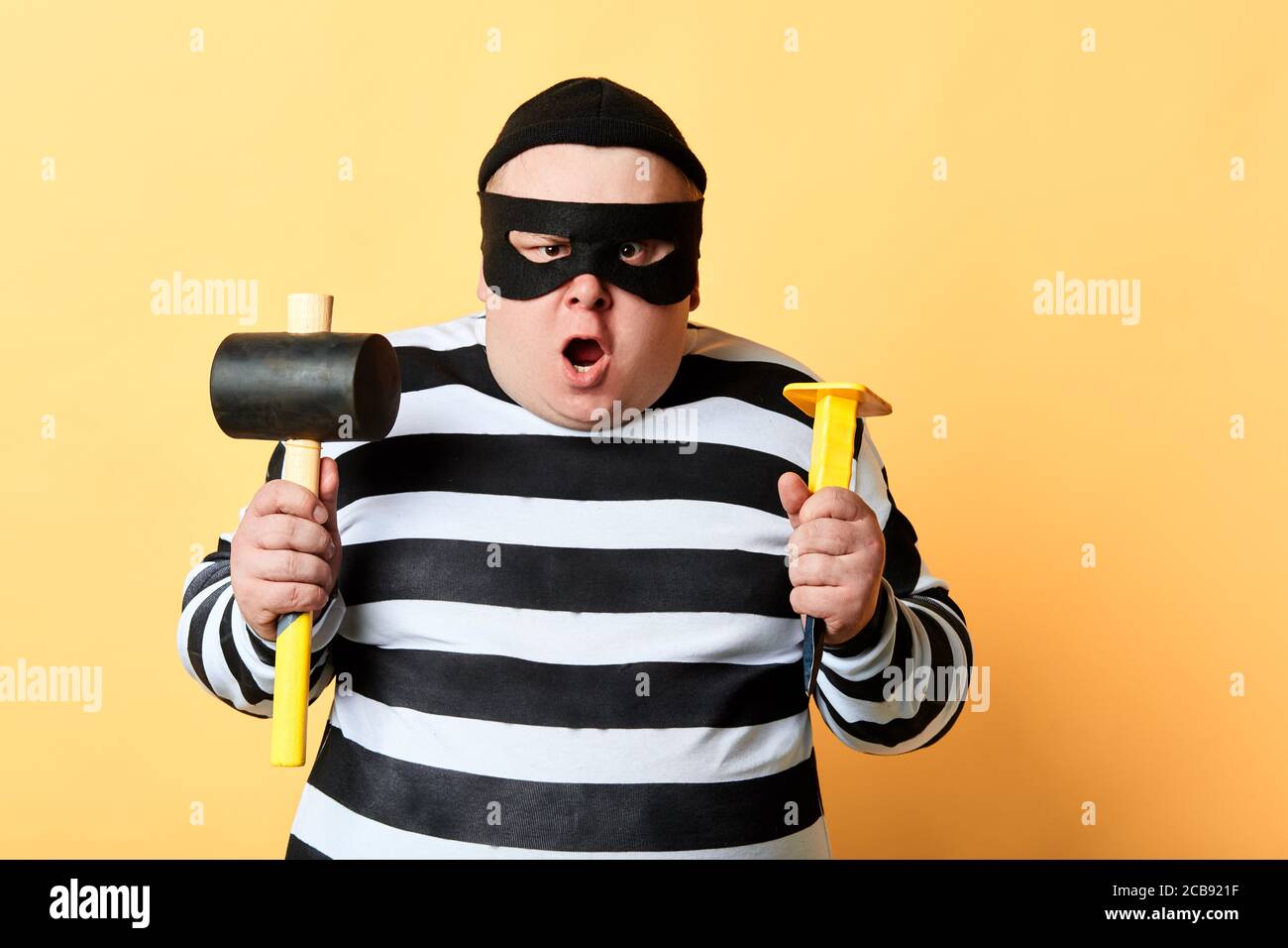 Man wearing balaclava and holding crowbar Stock Photo - Alamy