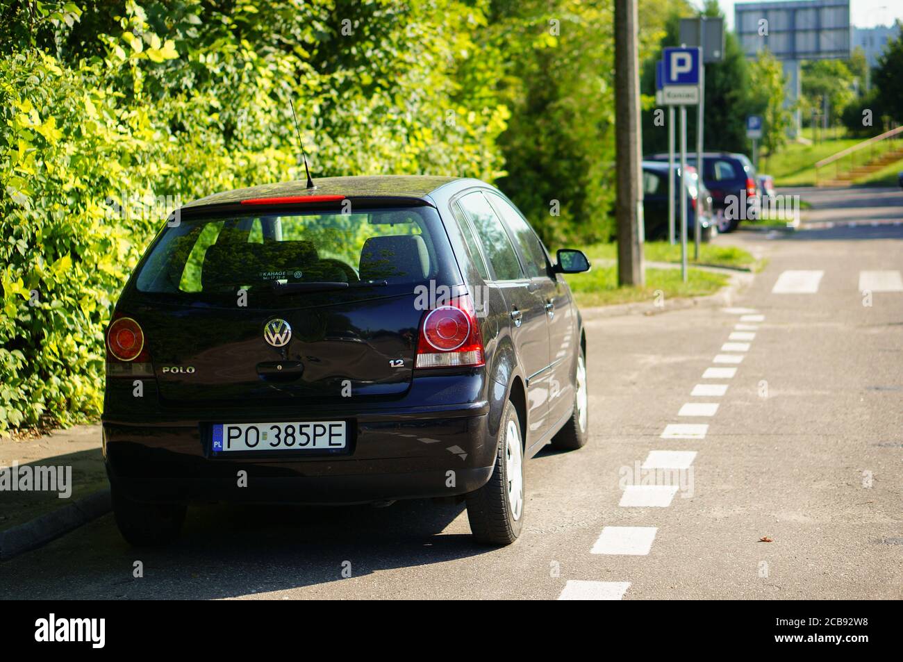 POZNAN, POLAND - Jul 29, 2020: Parked black Volkswagen Polo car on a  parking space next to green bush on a warm sunny day Stock Photo - Alamy