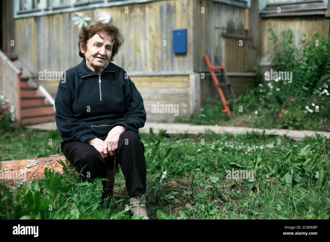 An Old woman in the country house Stock Photo - Alamy