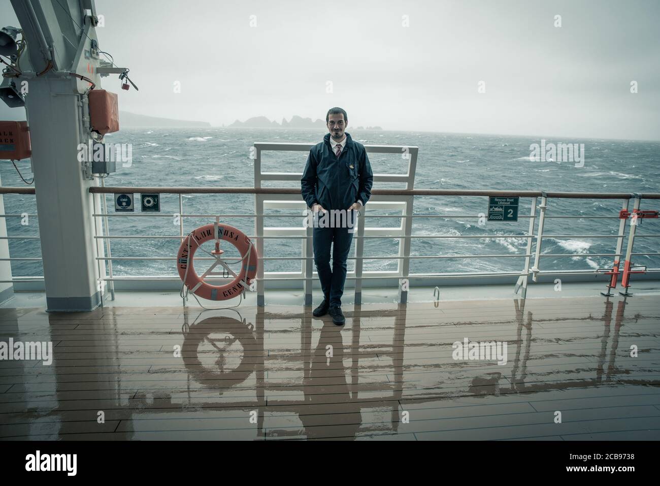 Winter 2019 Argentina A Young Man Is Standing With An Elegant Suit Under The Rain While The Cruise Ship Is Sailing Towards The Cape Horn Island Betw Stock Photo Alamy