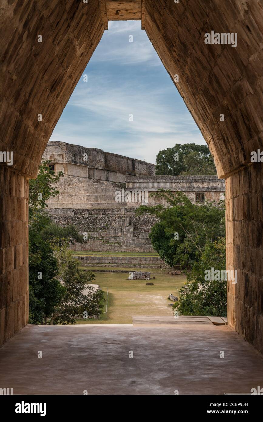 The main entrance into the Nunnery Quadrangle is through a corbel arch doorway in the center of the south building in the pre-Hispanic Mayan ruins of Stock Photo