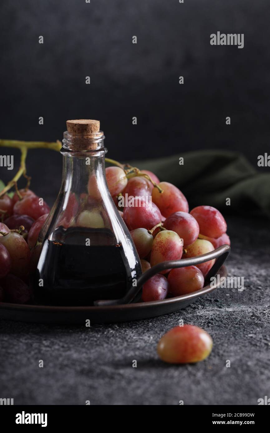 balsamic vinegar in a glass bottle and fresh grapes Stock Photo Alamy