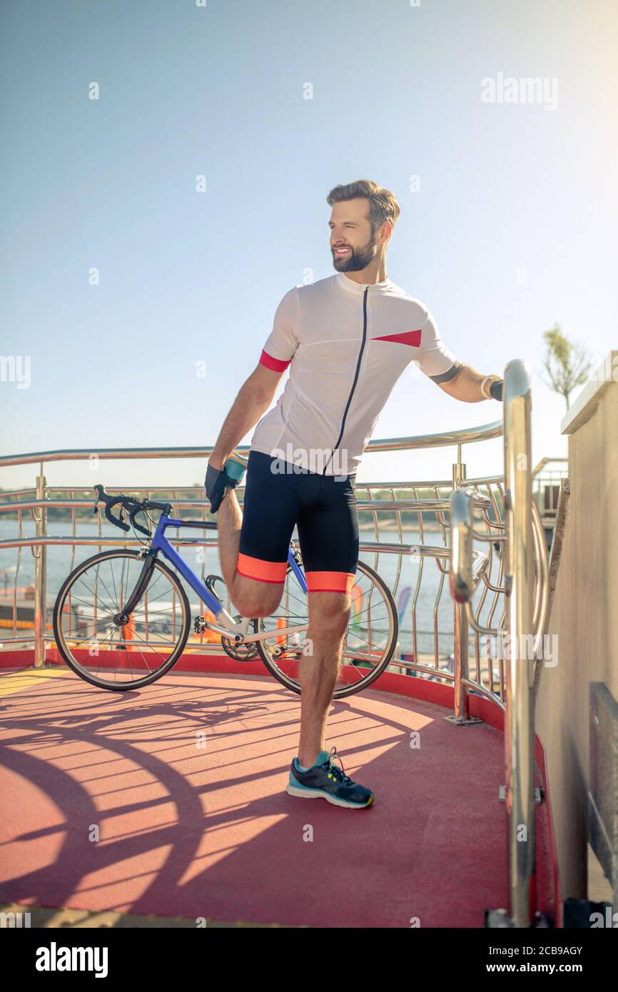 Young man stretching on bridge hi-res stock photography and images - Alamy