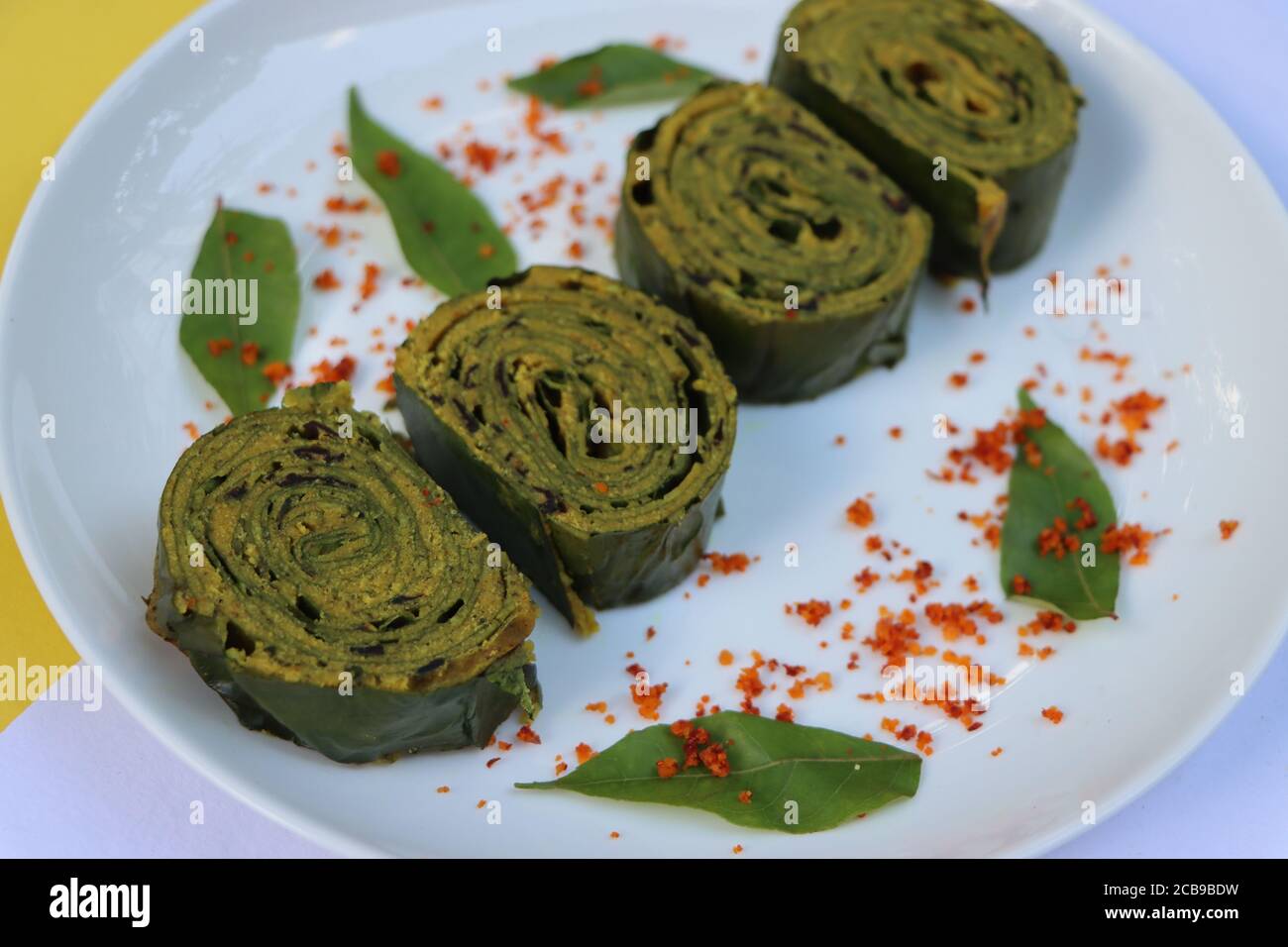 Patra or Paatra or Alu Vadi or Alu wadi is a popular maharashtrian and Gujarati snack made using colocasia leaves, gram flour and flavourings spices Stock Photo