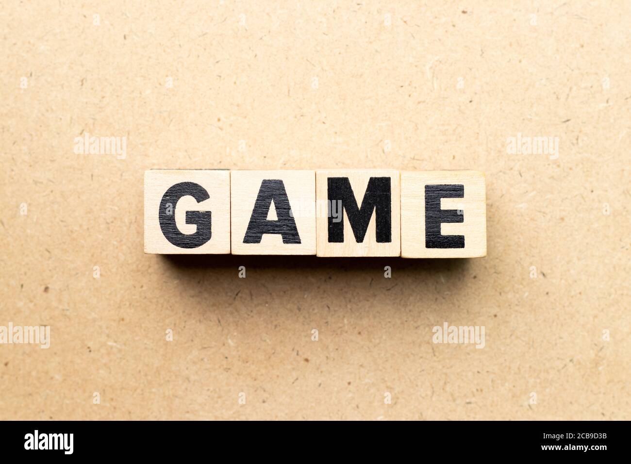 Letter block in word game on wood background Stock Photo - Alamy