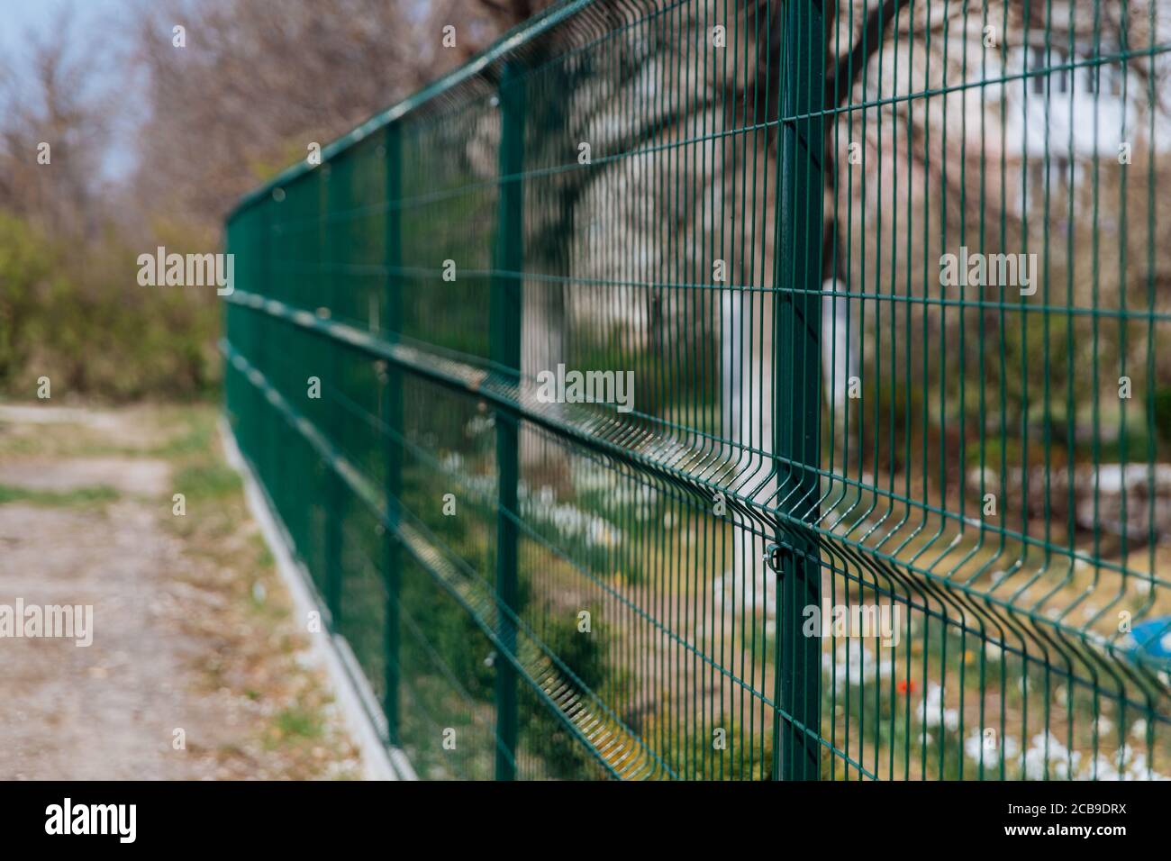 Steel grill. Green fence with wire. Fencing. Stock Photo