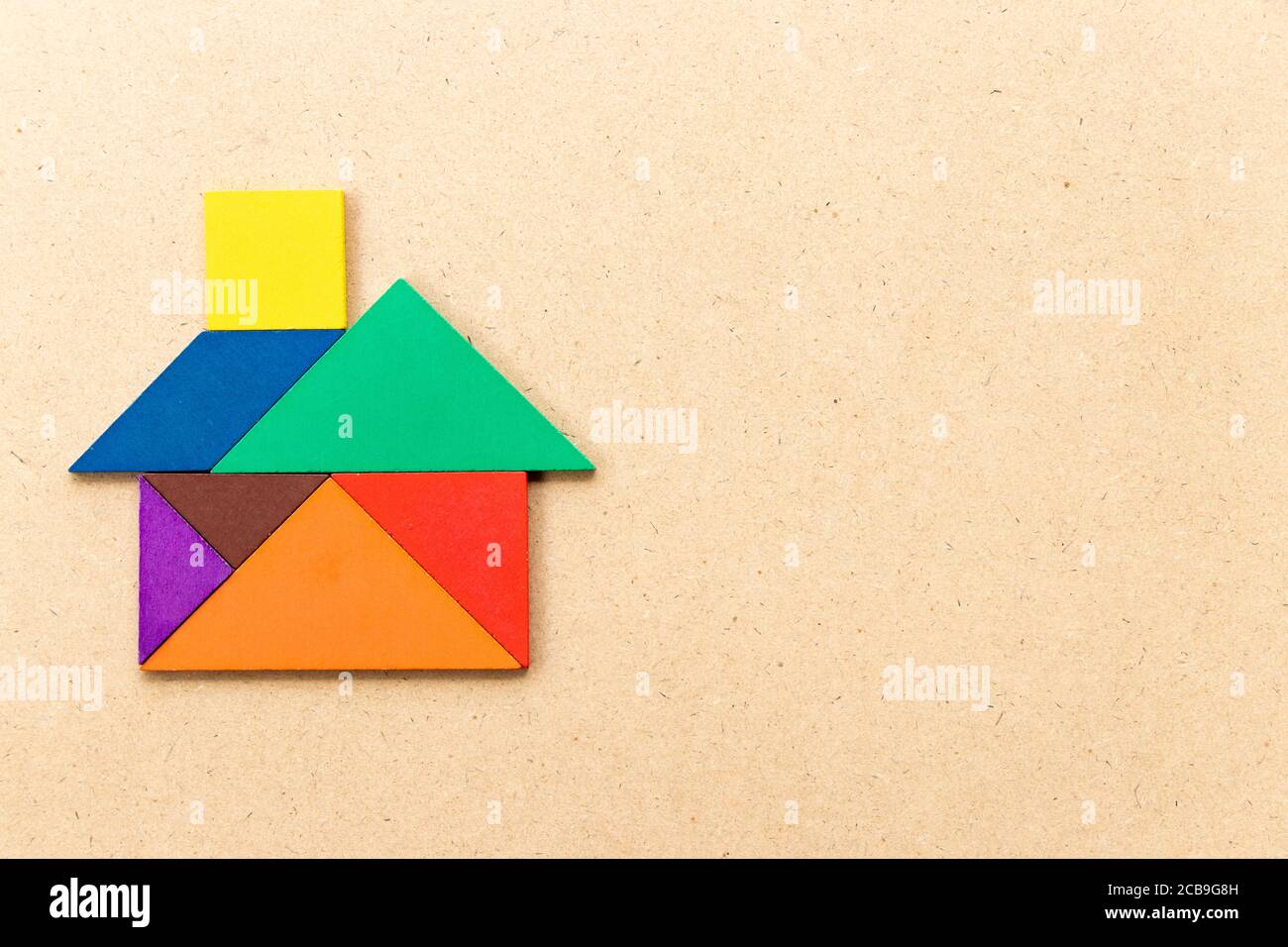 Color tangram puzzle in house or home shape on wood background Stock ...