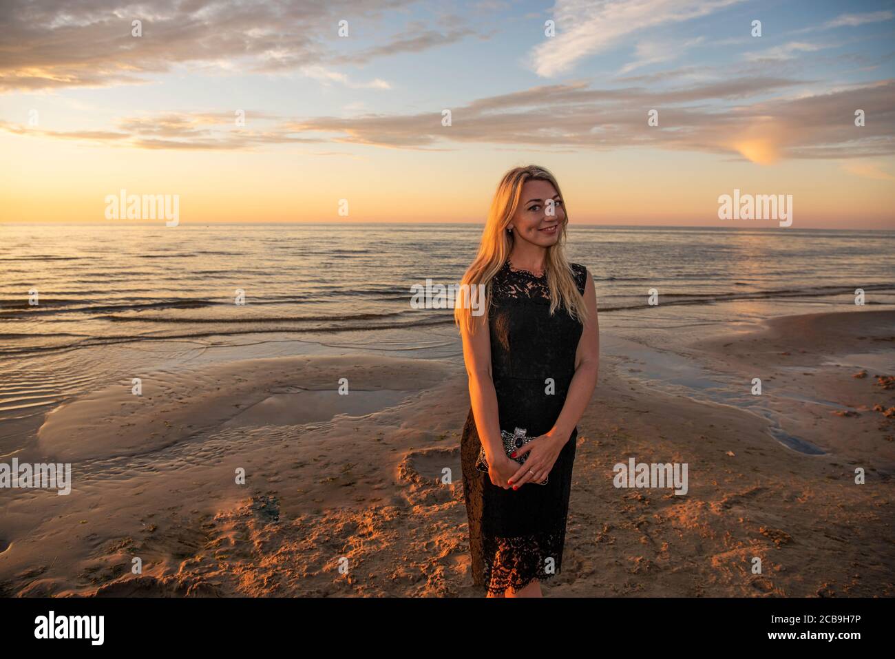 Beautiful young woman relaxing at sunset Stock Photo