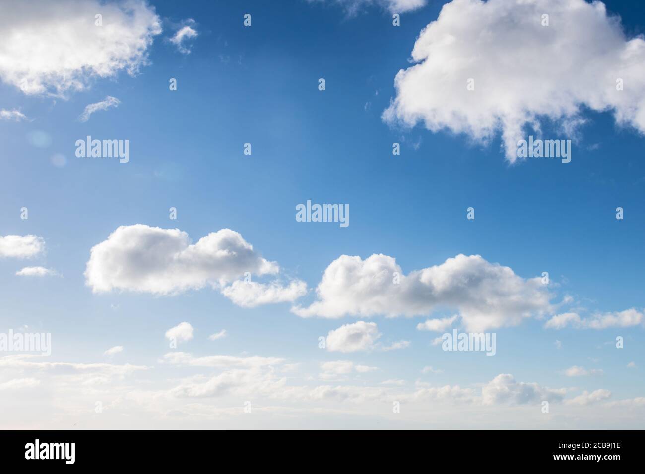 Low angle shot of the white fluffy clouds in the beautiful blue sky ...