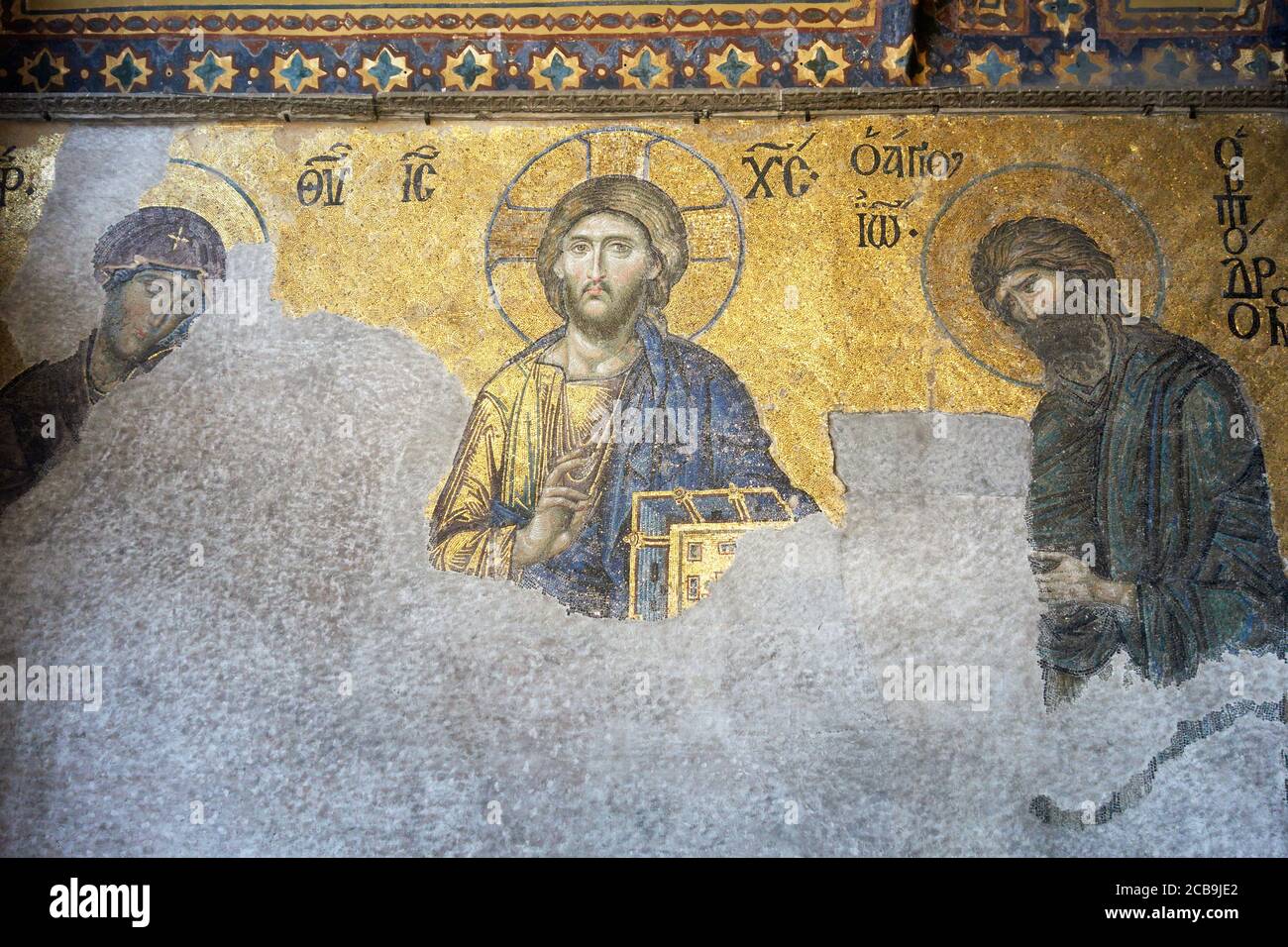 The Deësis mosaic, ancient Christian art showing Christ, Virgin Mary and John the Baptist, on the upper gallery inside Hagia Sophia. Istanbul. Turkey. Stock Photo