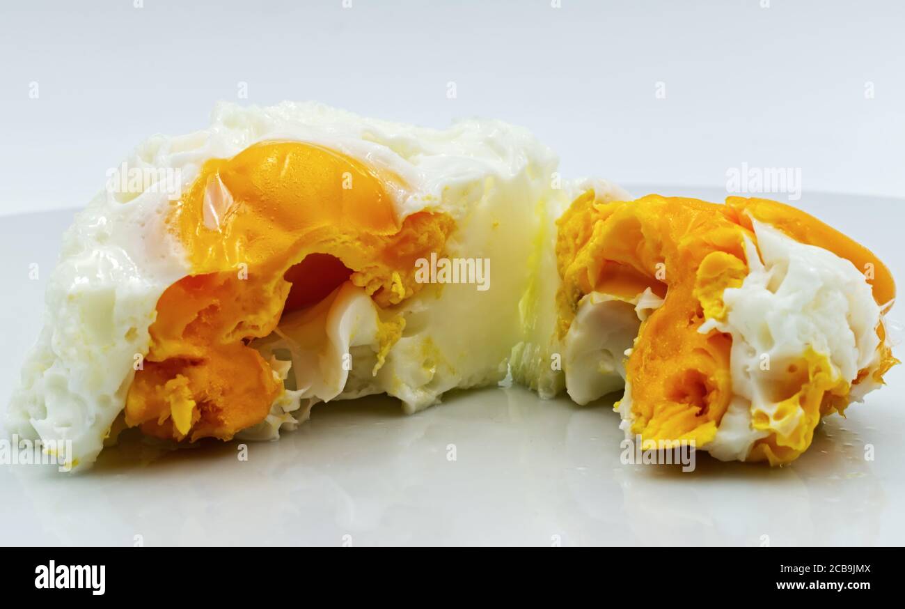 Boiled egg on a white plate, isolated on white background Stock Photo